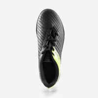 حذاء كرة قدم برباط للعب على النجيلة للأطفال - 100 TF أسود\أصفر