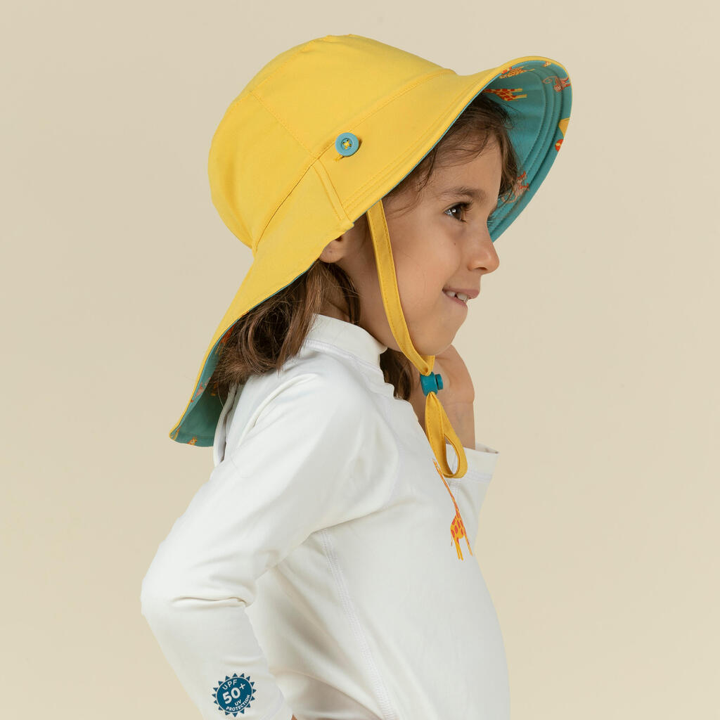Bērnu divpusēja UV aizsardzības cepure, dzeltena un zila, ar savannas apdruku