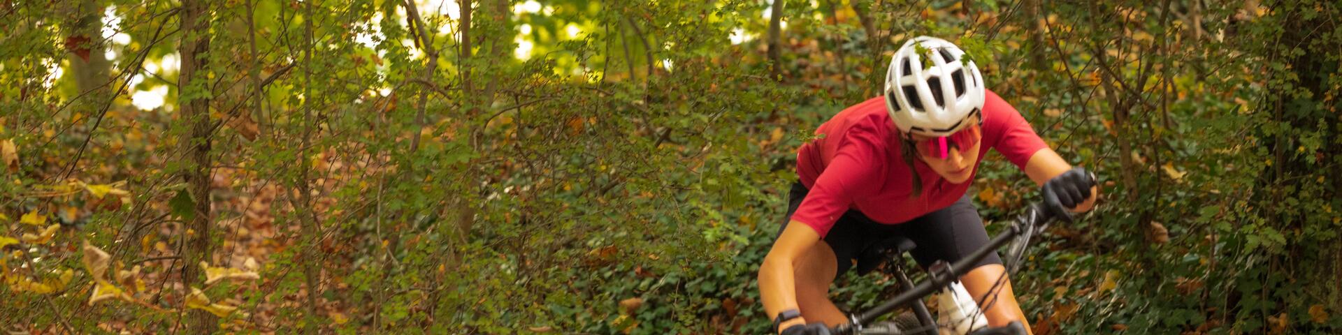Man riding bike on a trail, wearing a helmet