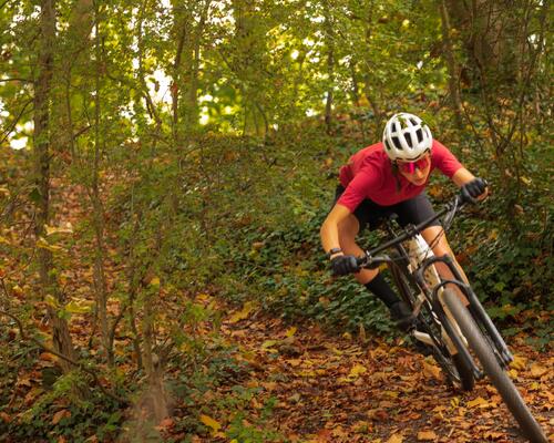 Man riding bike on a trail, wearing a helmet