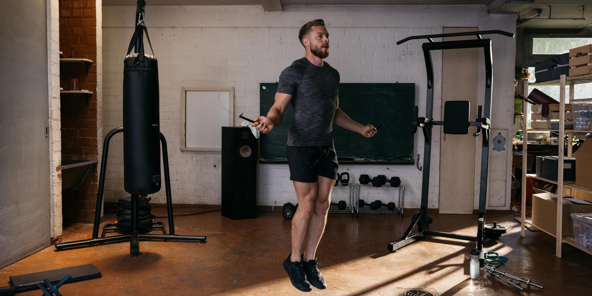 Man skipping rope in home gym. 