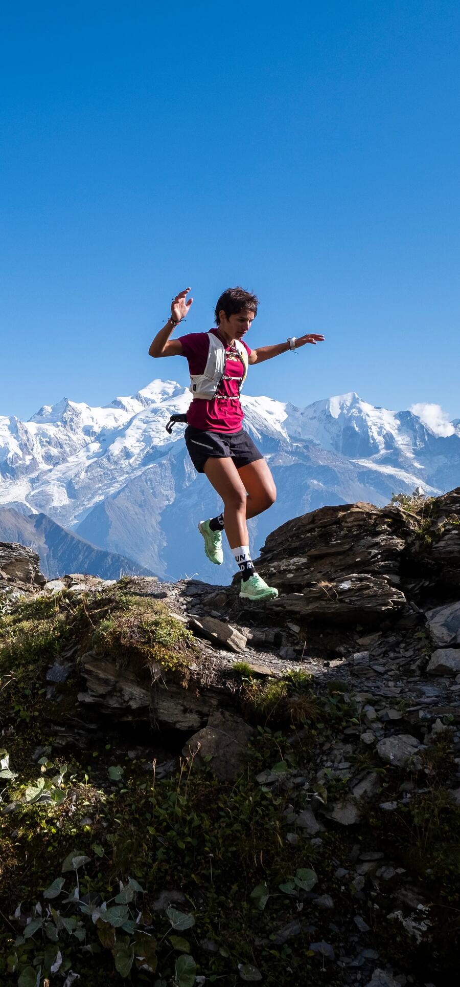 woman running on a rocky mountain trail 