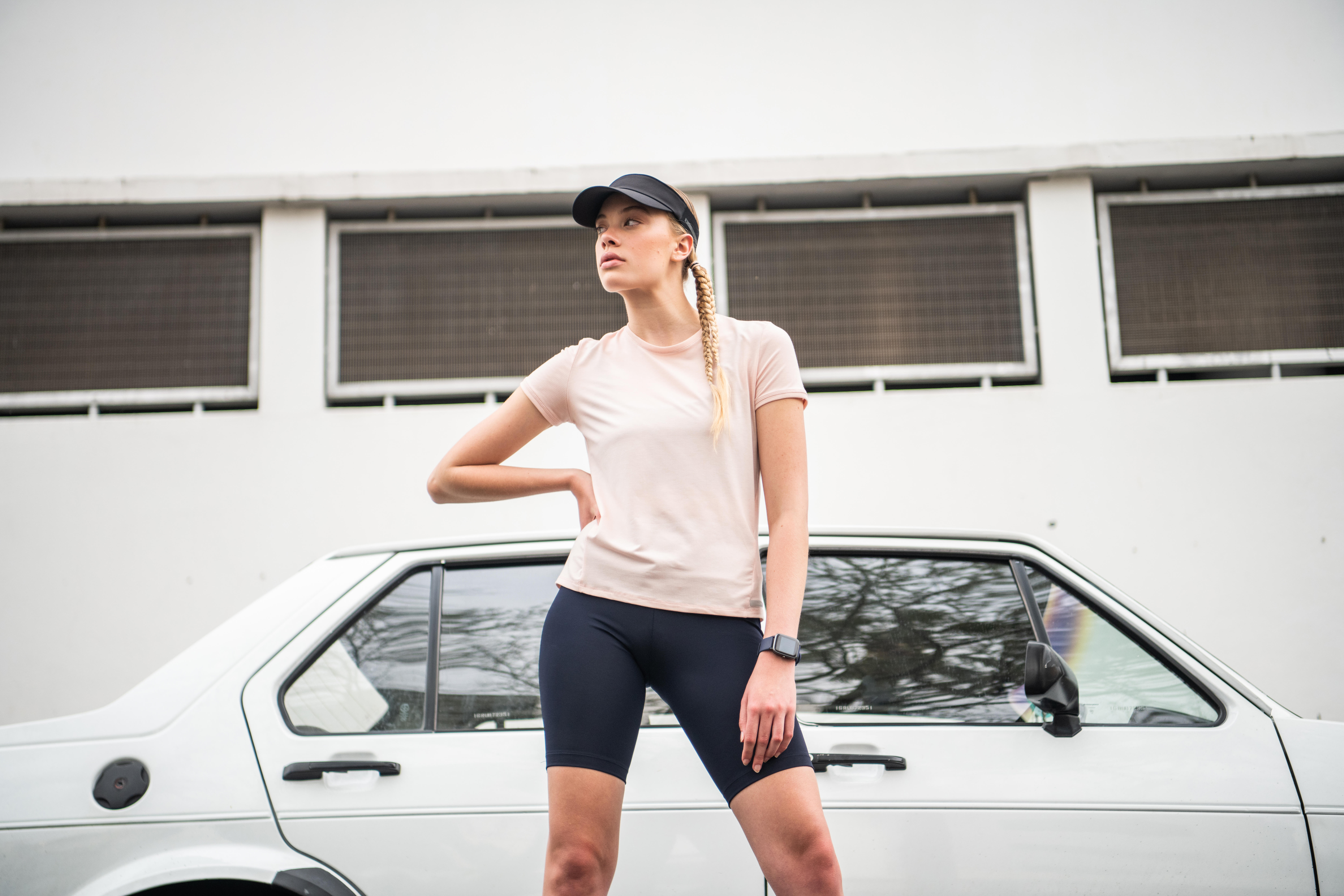 Person wearing a fitness tracker watch while standing outdoors