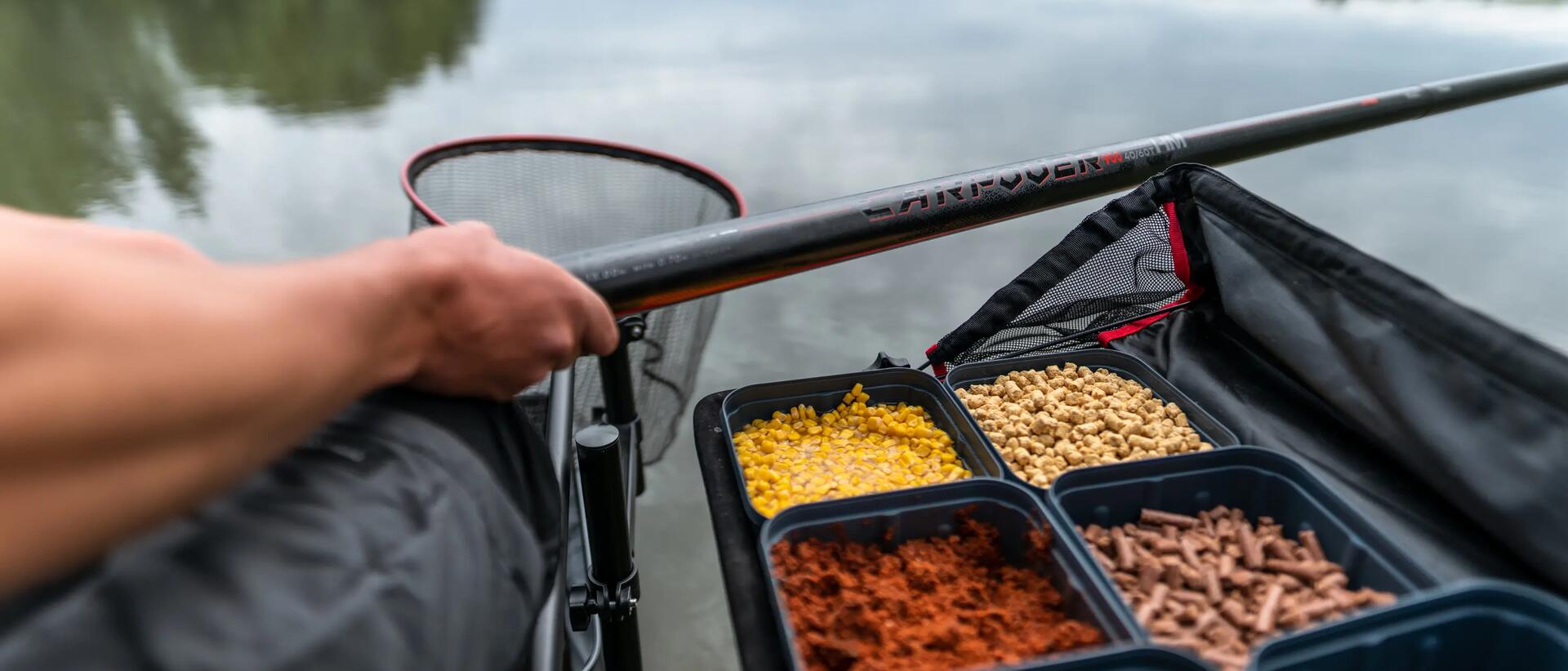 Man fishing with trays of bait next to him