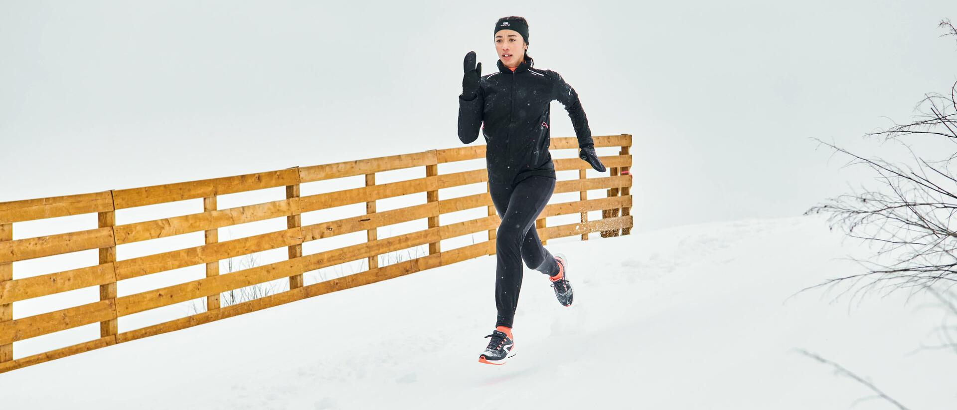 Woman running in winter snowfall