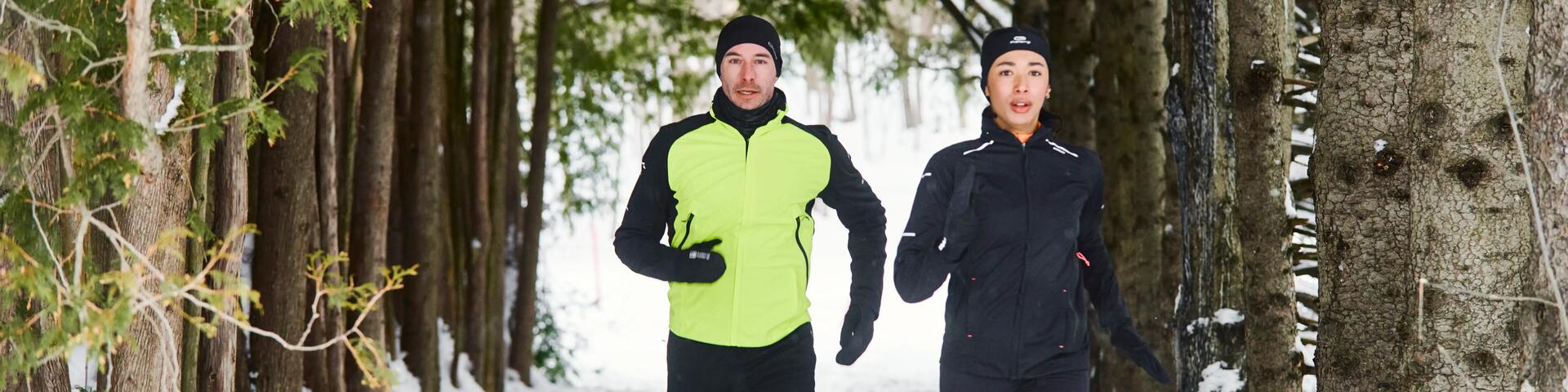 Couple running in Winter, through forest