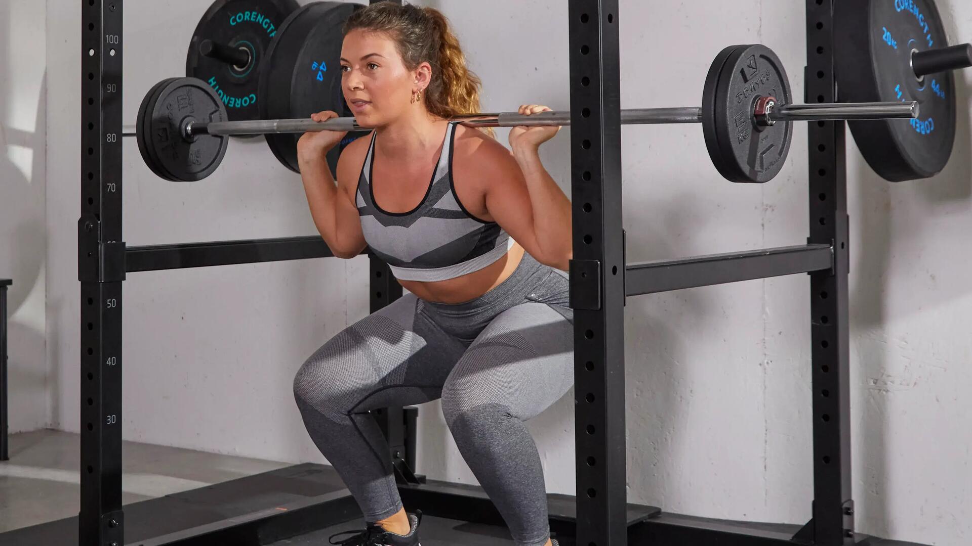 Vrouw die een squat doet met gewichten