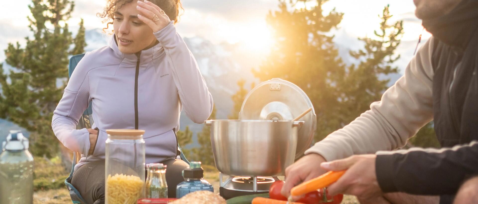 Couple preparing their meal while camping
