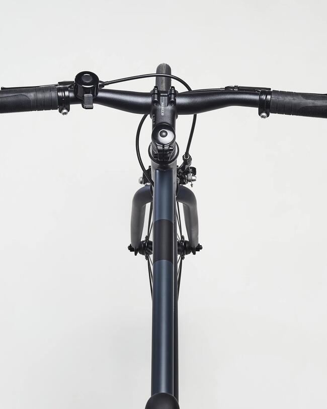 Detailaufnahme Ein-Gang-Schaltung am Hinterrad an gelben Fahrrad; vor grauer Hauswand