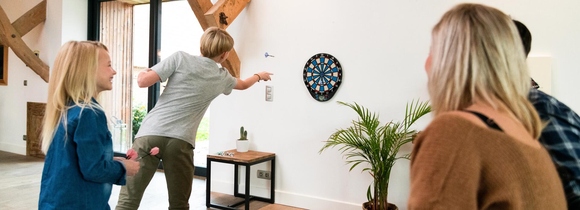 Family playing darts at home