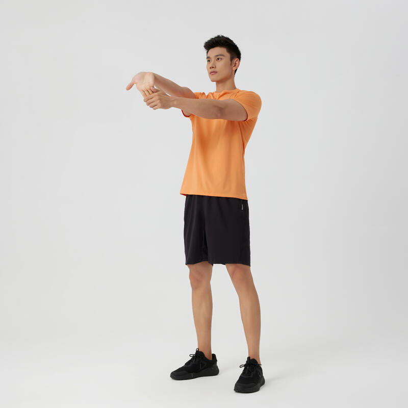 Ademend fitnessshirt voor heren Essential ronde hals oranje