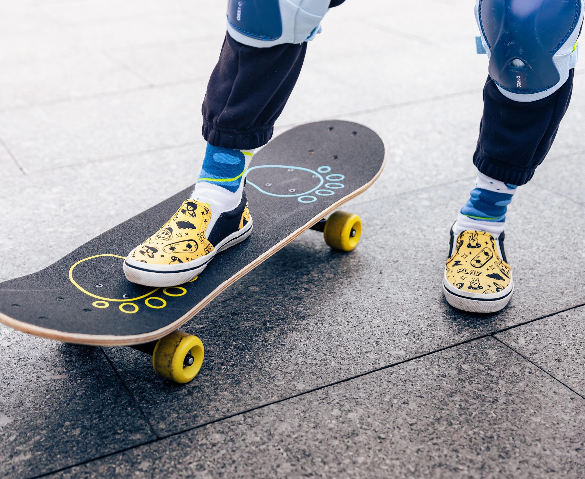 A close of feet and skateboard with the left on the ground