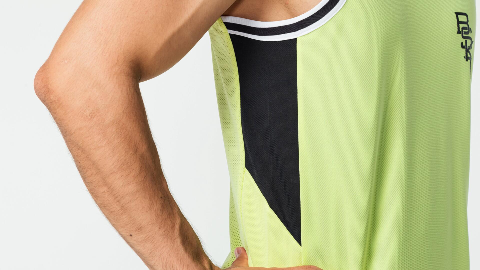 Close up of man wearing basketball vest and arm.