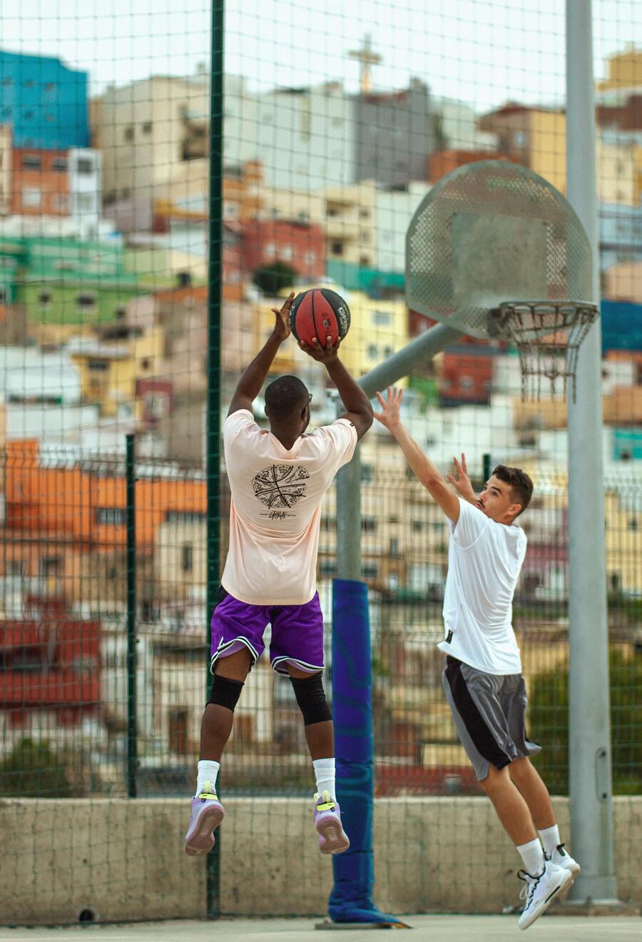 Two men playing outdoor basketball