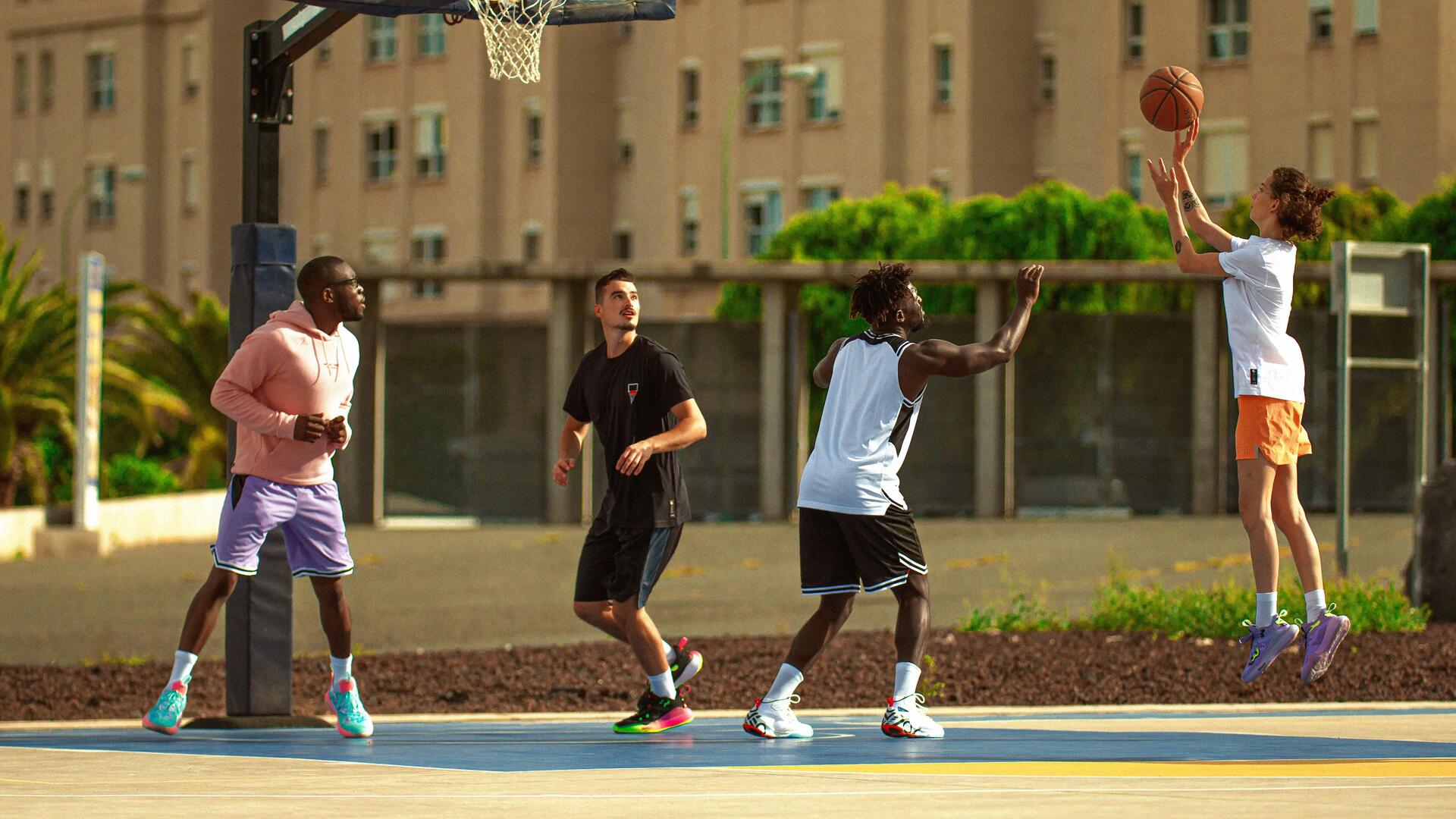 Two men playing basketball in the park