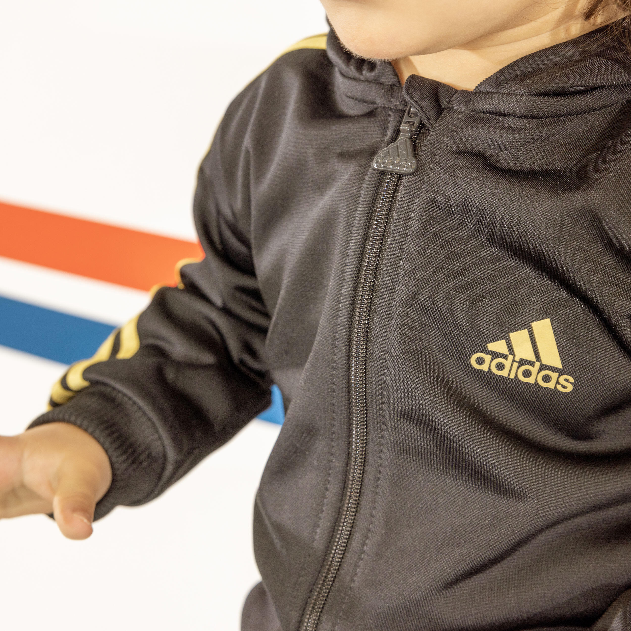 ADIDAS Trainingsanzug Baby schwarz gold ADIDAS DECATHLON
