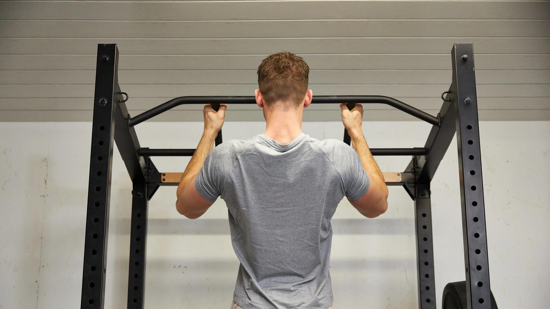 Man doing pull ups on pull up bar