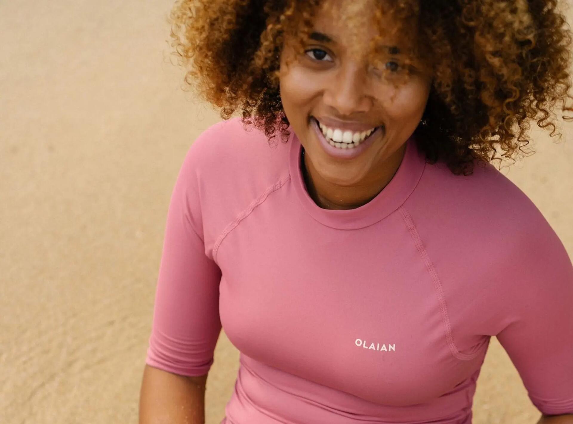 kobieta w bluzce z filtrem UV siedząca na plaży 