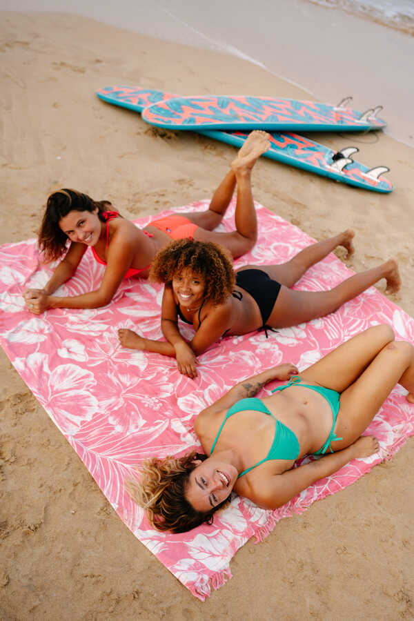 Girls are getting a sun tan on the beach