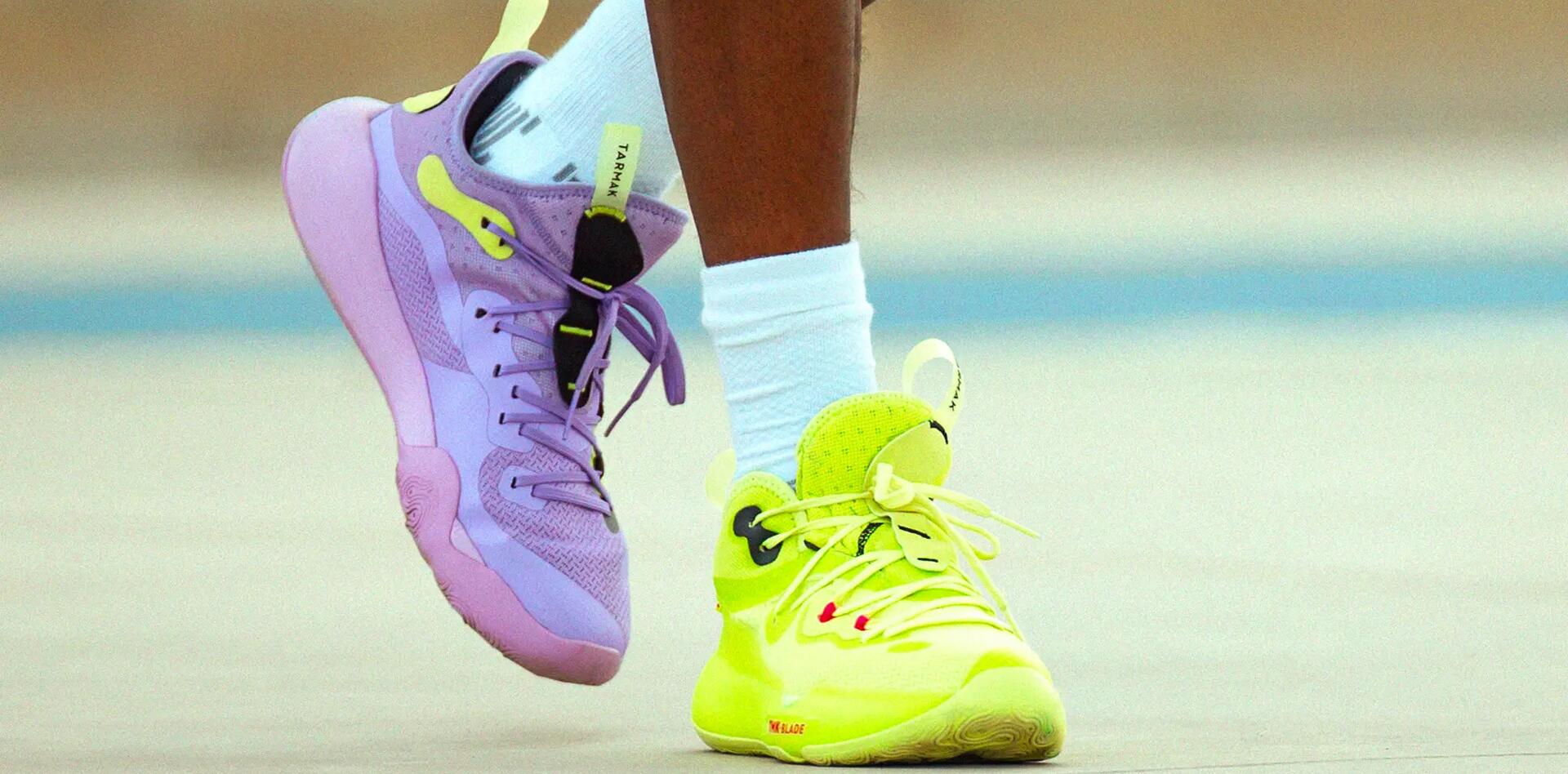 A close up purple and yellow basketball shoes