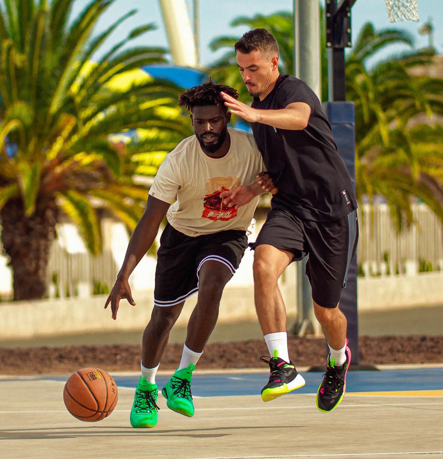 Two people playing basket on a basketball court