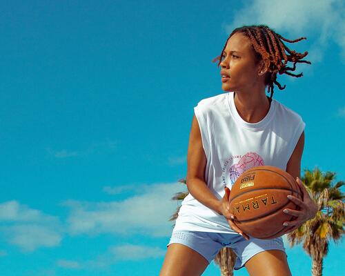 Girl holding Tarmak basketball in hands