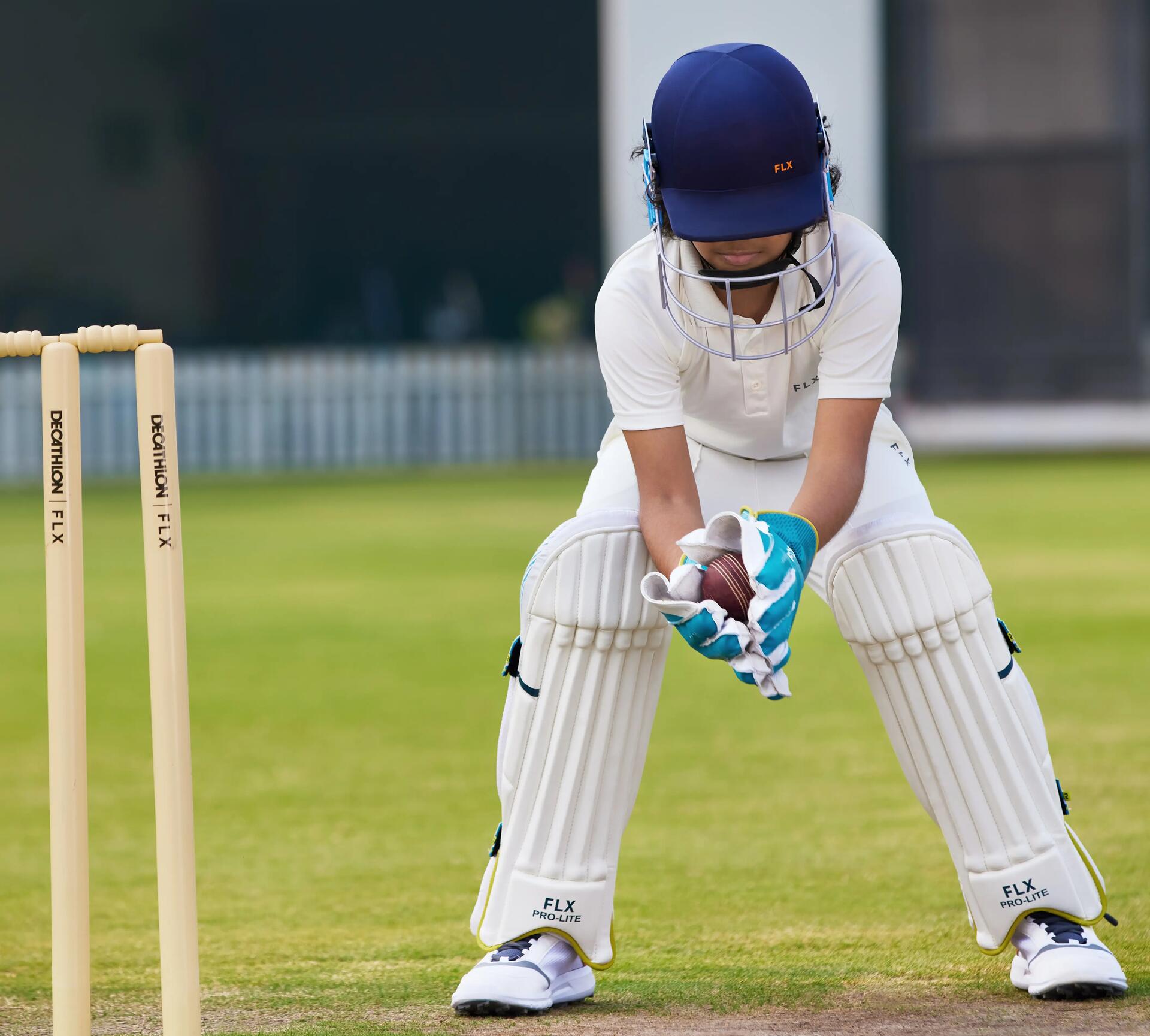 Wicket-keeper wearing a cricket helmet