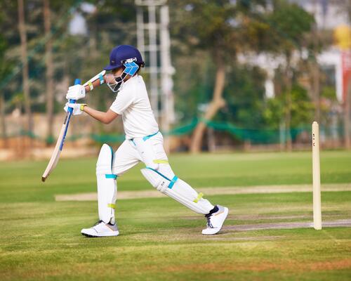 Kid playing cricket