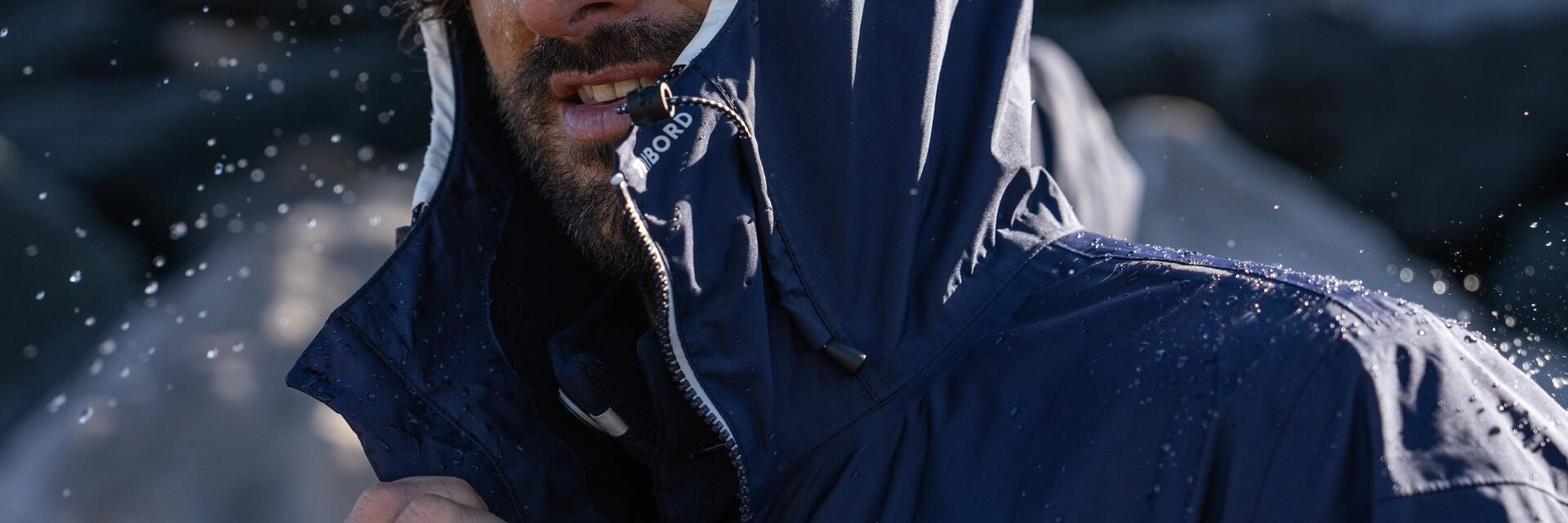 men smiling in the rain wearing a rain jacket