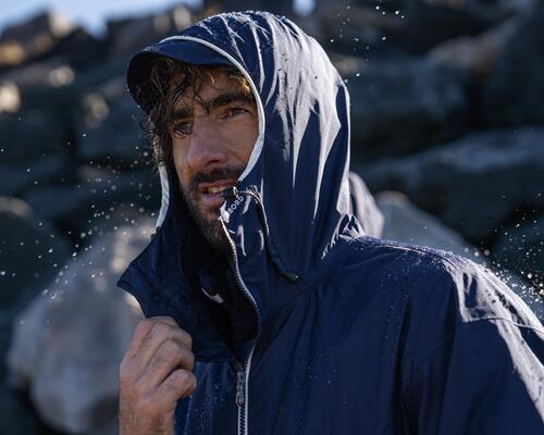 men smiling in the rain wearing a rain jacket