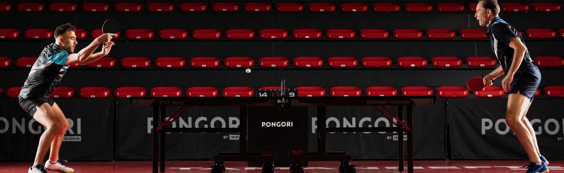 Two men playing advanced indoor table tennis