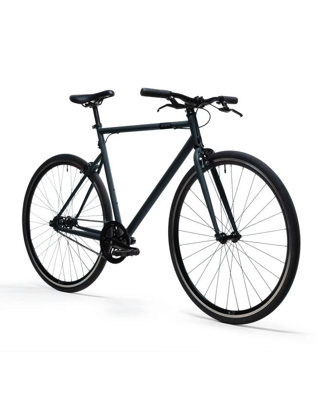 Gelbes Fahrrad mit schwarzem Lenker vor grauer Hauswand