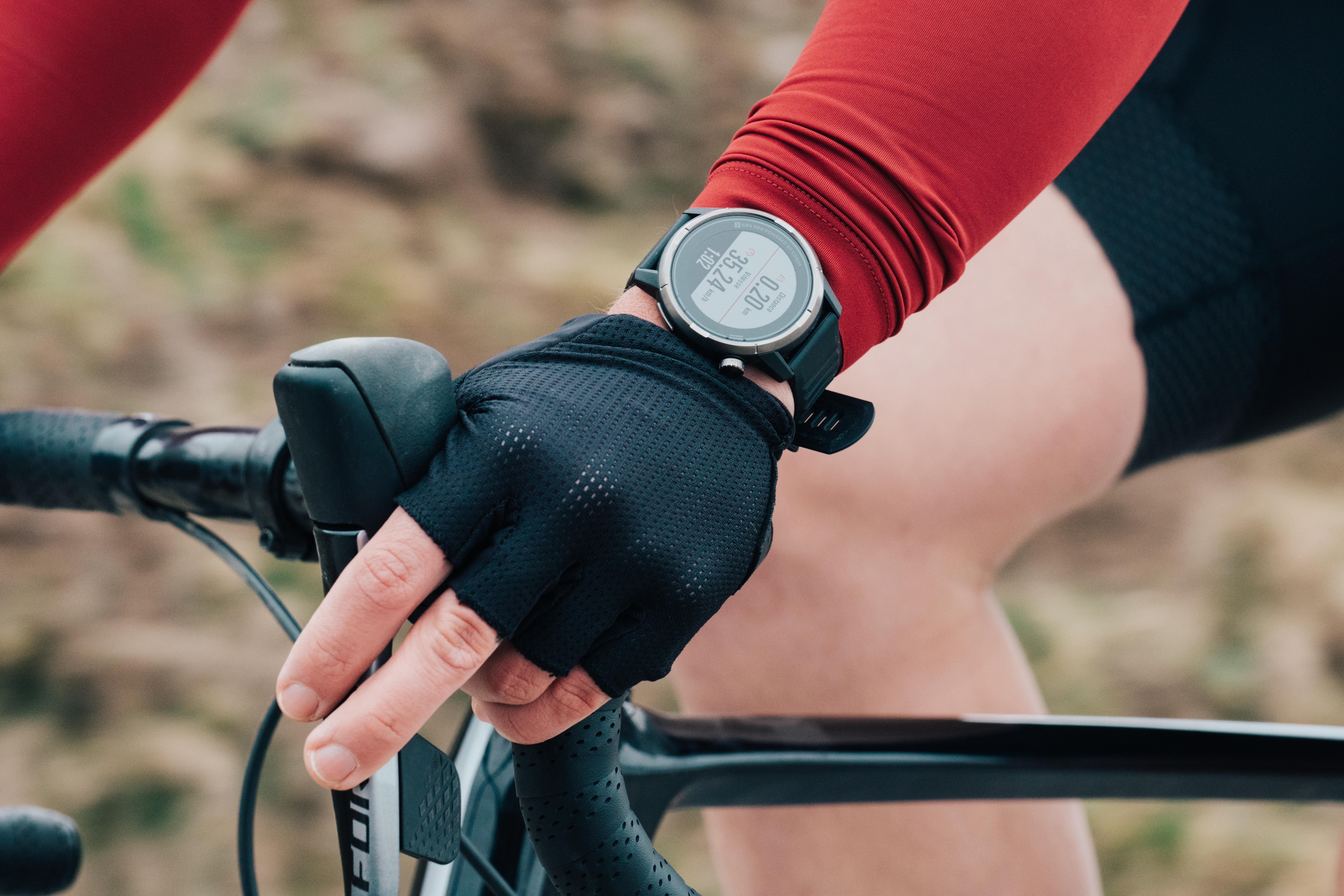 Cyclist wearing a sports watch while riding a bicycle