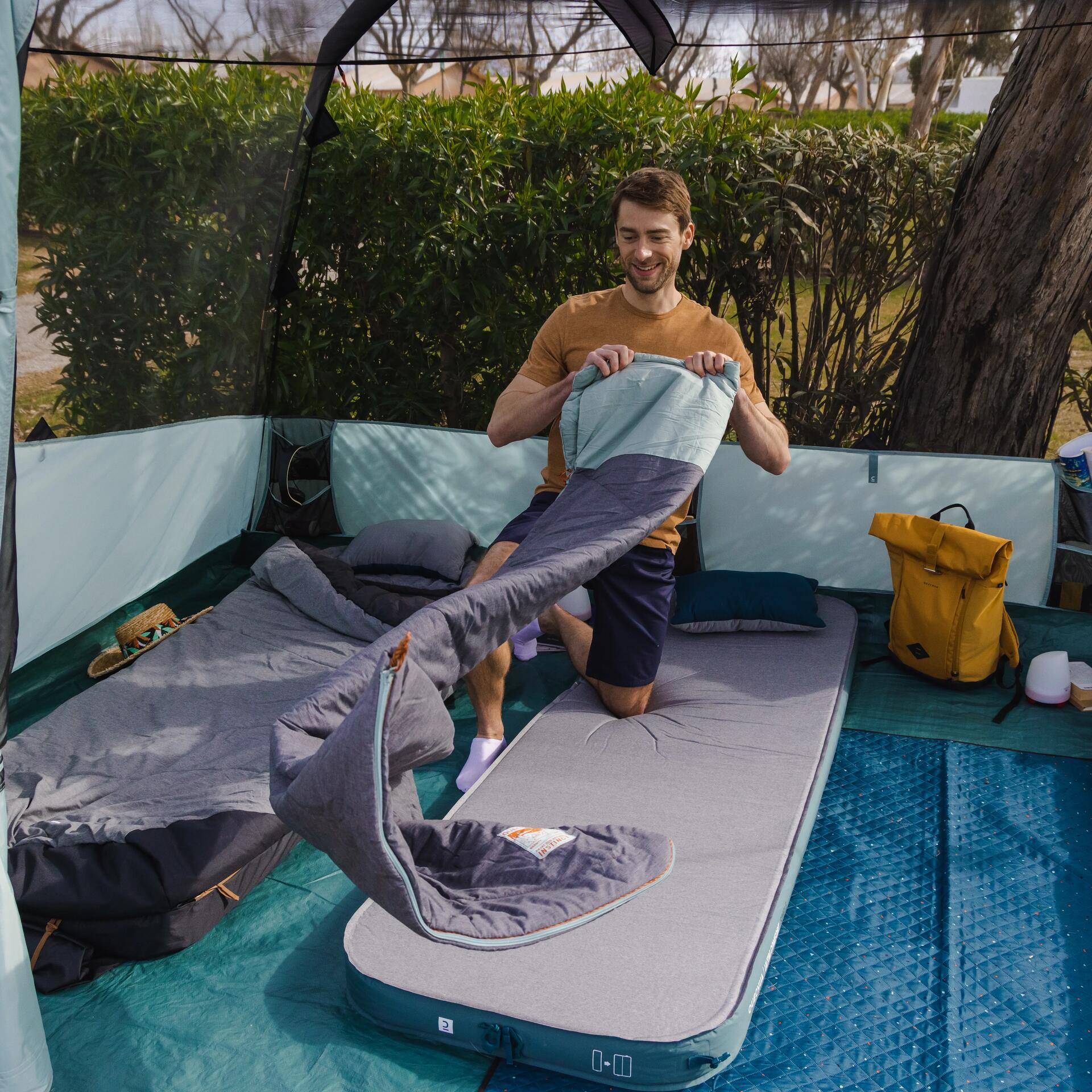 A guy standing on a camping mattress