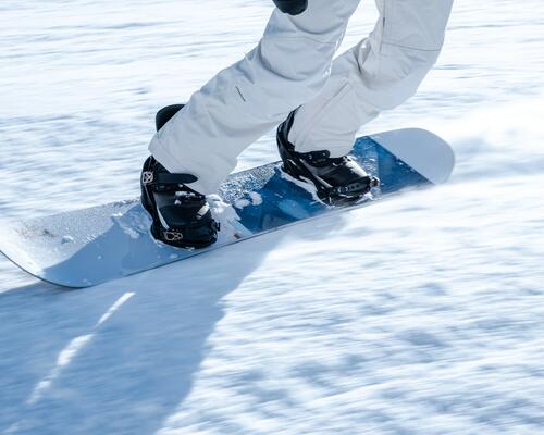 Friends rinding their snowboards on the slope