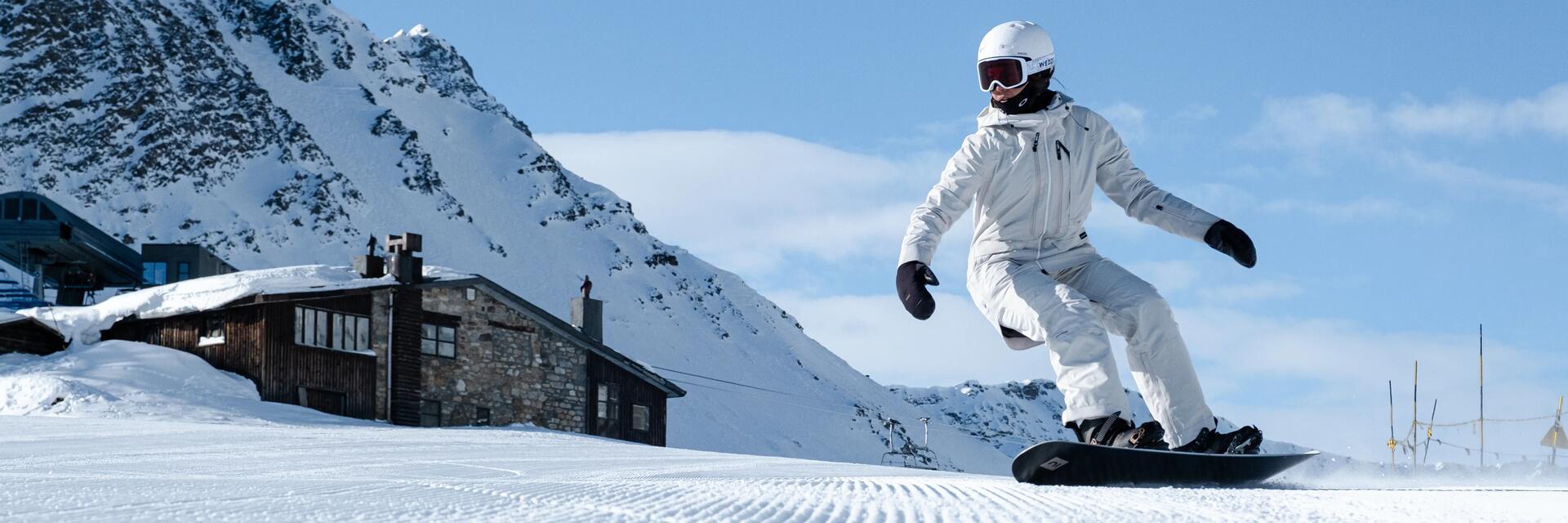 posición encima de una tabla de snowboard