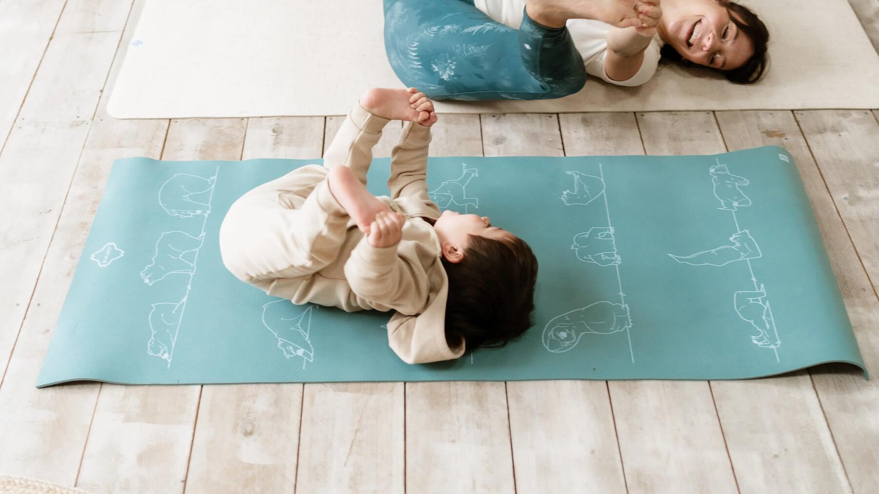 a little boy explores yoga on a mat