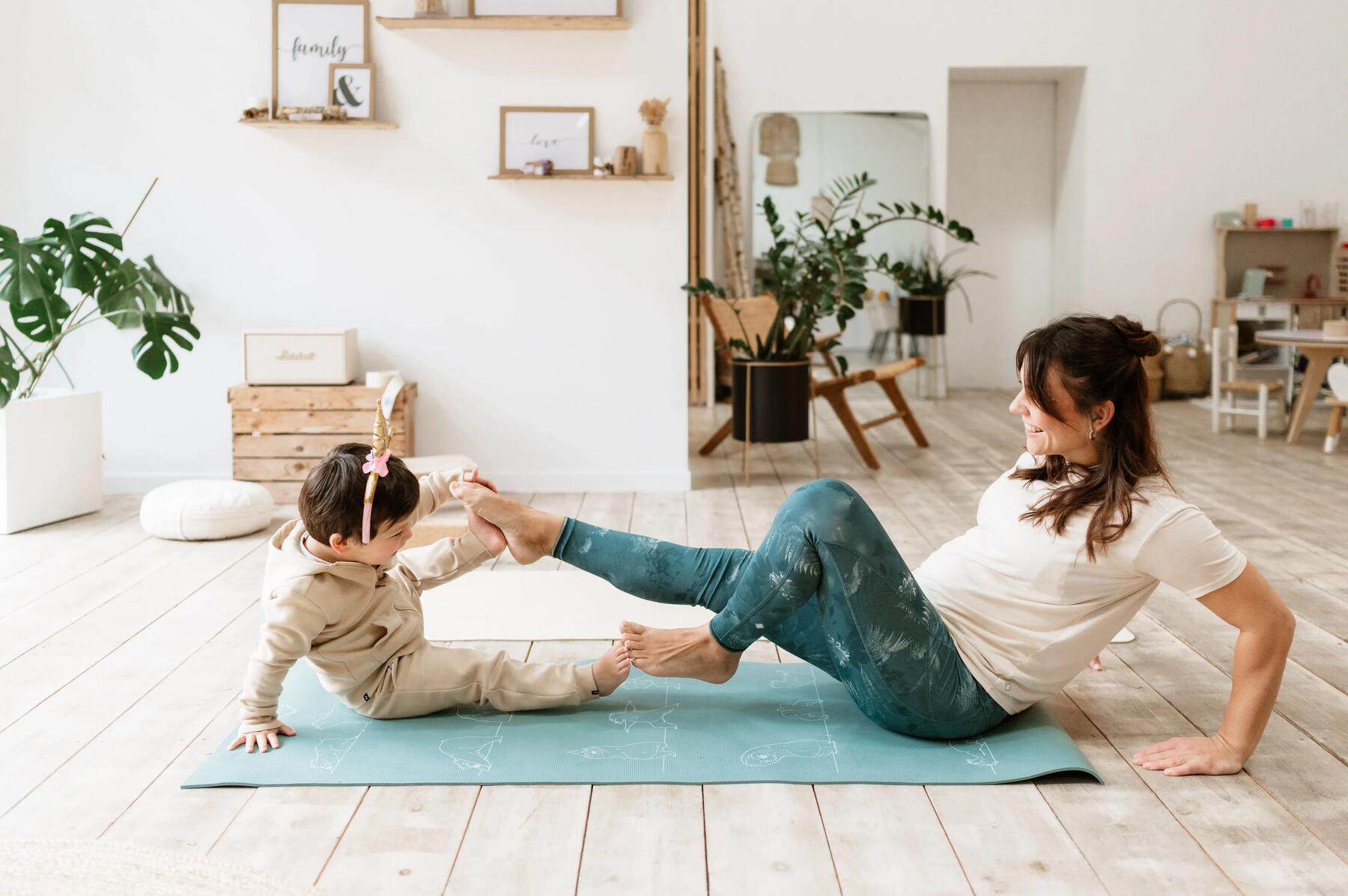 young girl doing a somersault on her mat