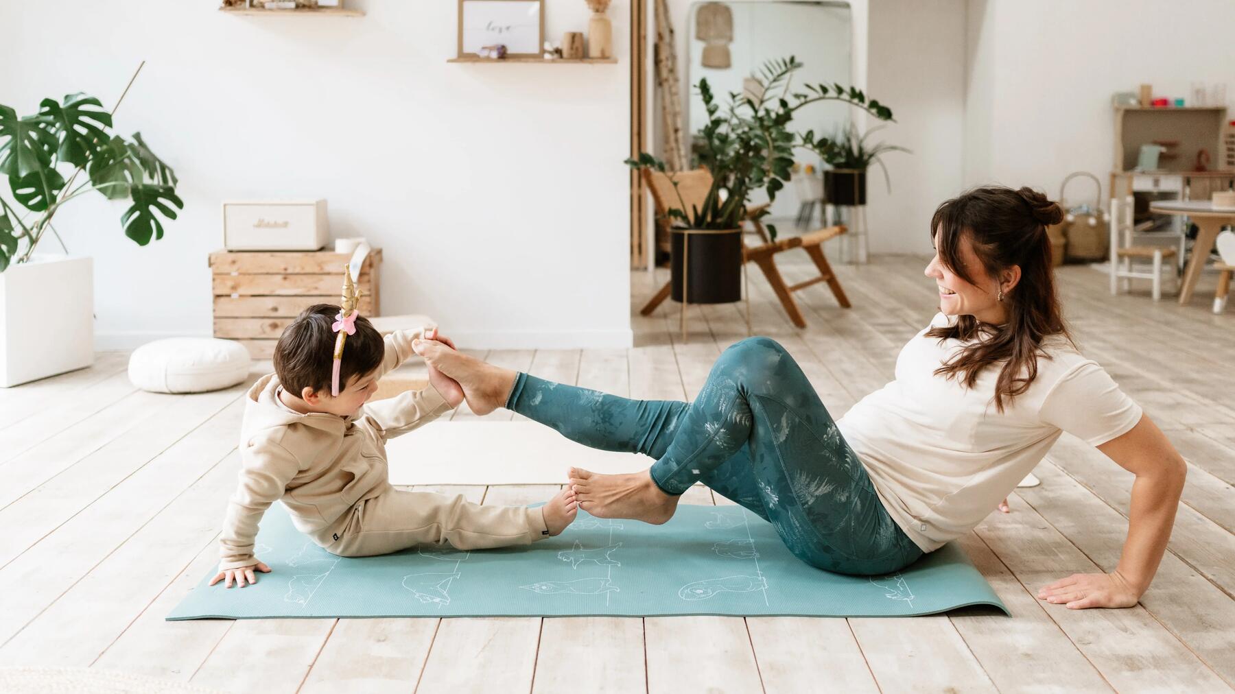 Mother and daughter do yoga 