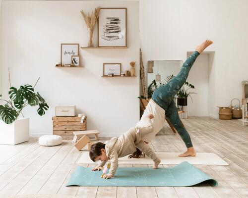Mum doing yoga with daughter