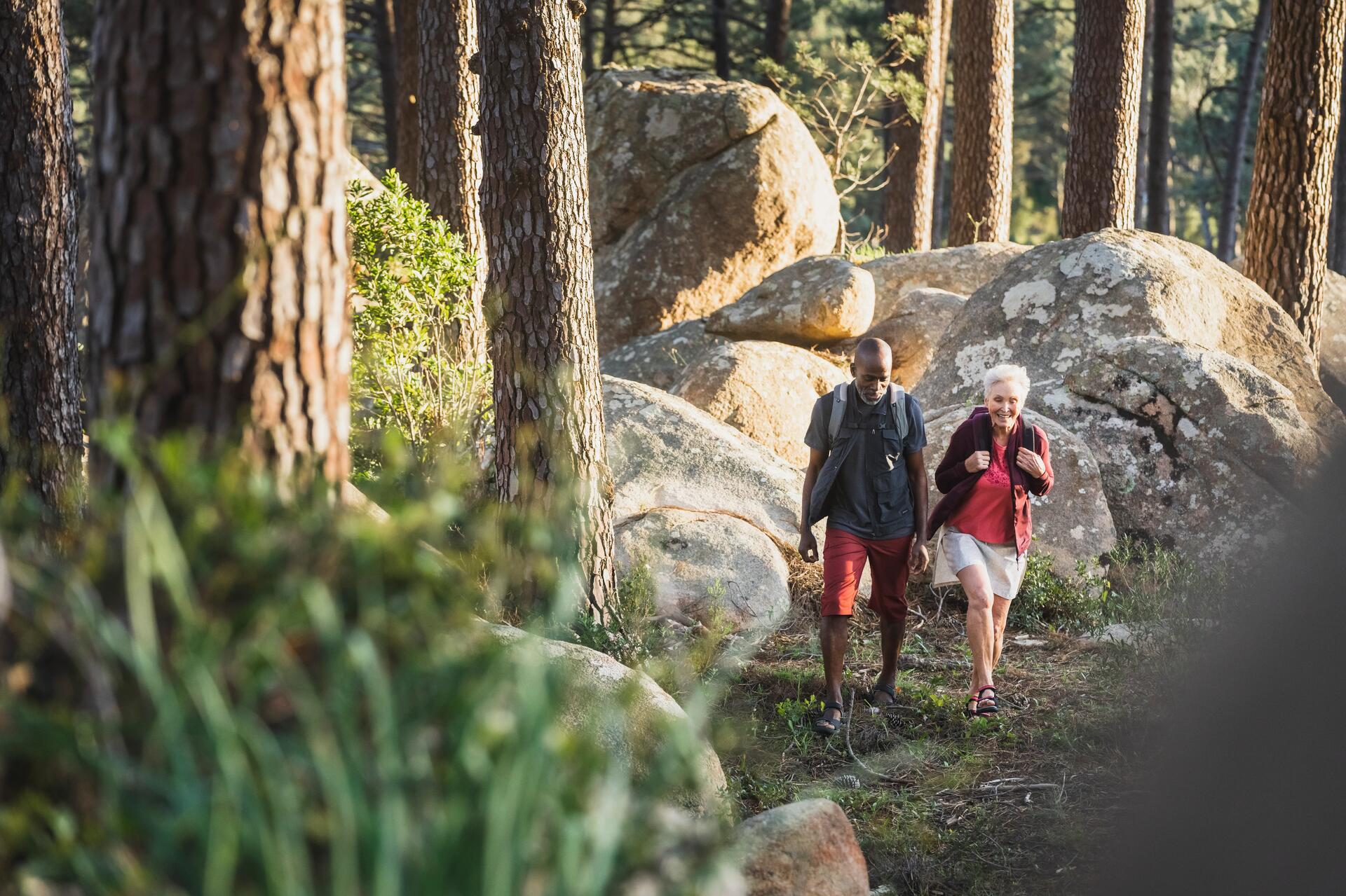 Mężczyzna i kobieta idący w sandałach trekkingowych po górach