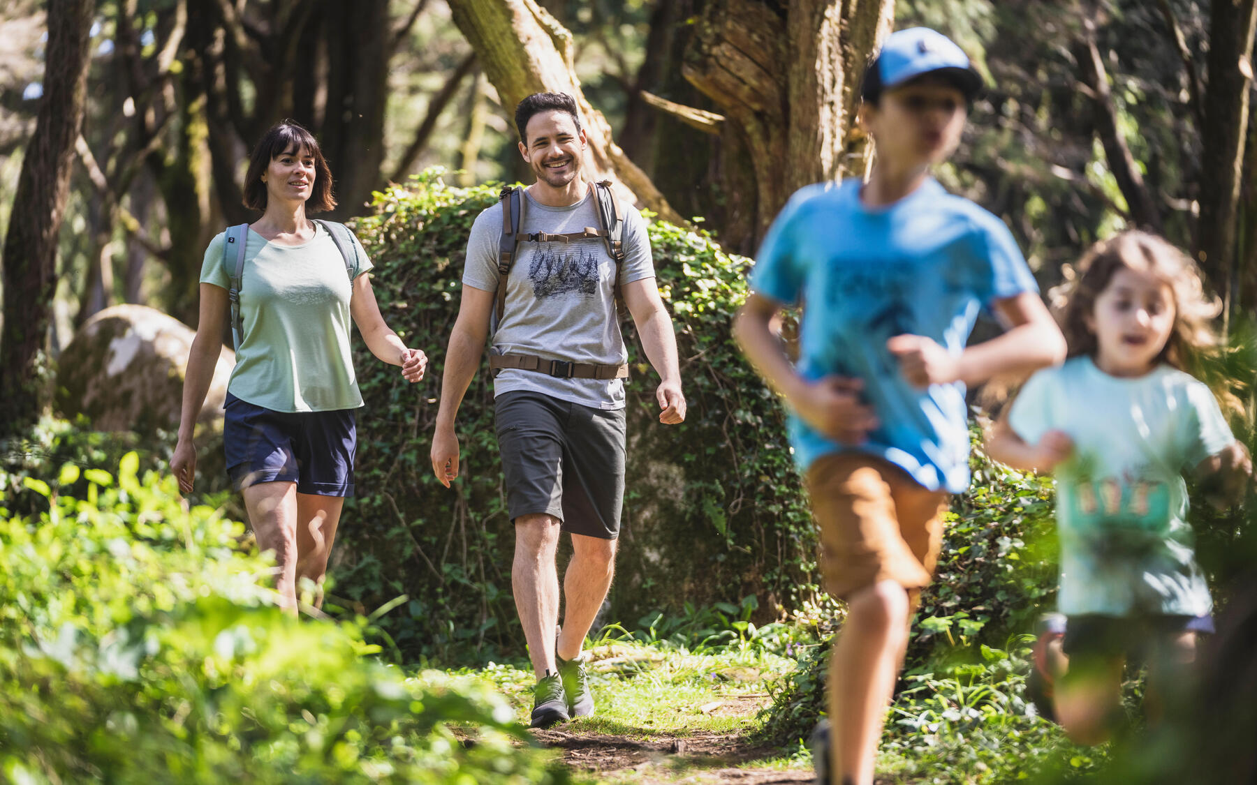 Family walking on a path in a forest. 