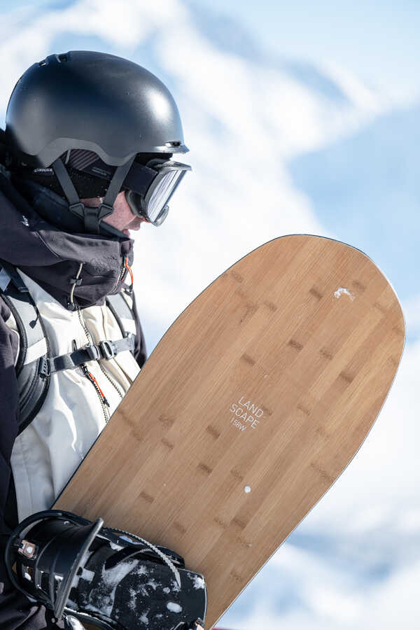 Image of a man with snowboard in his hand