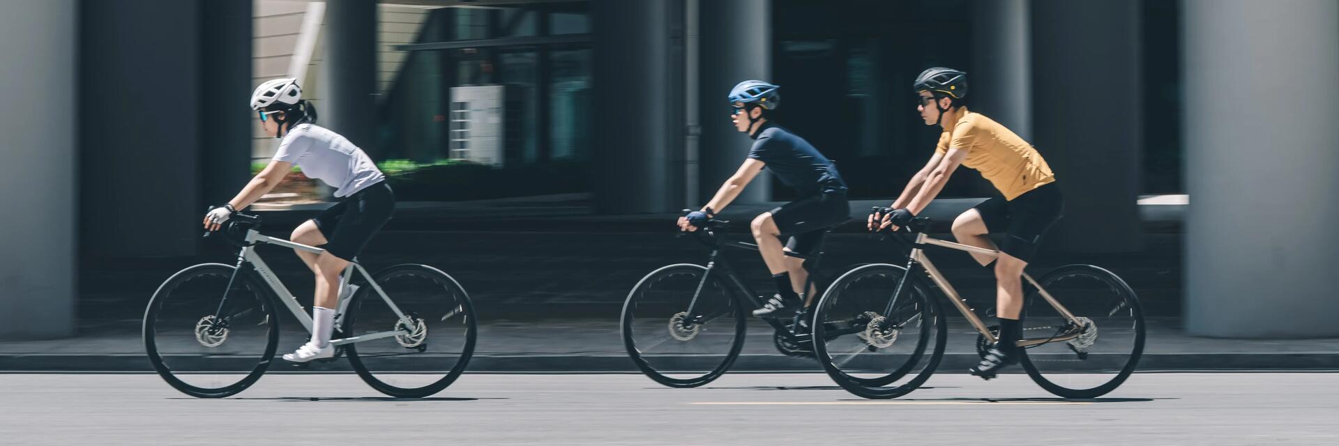 Three cyclists riding Van Rysel bikes