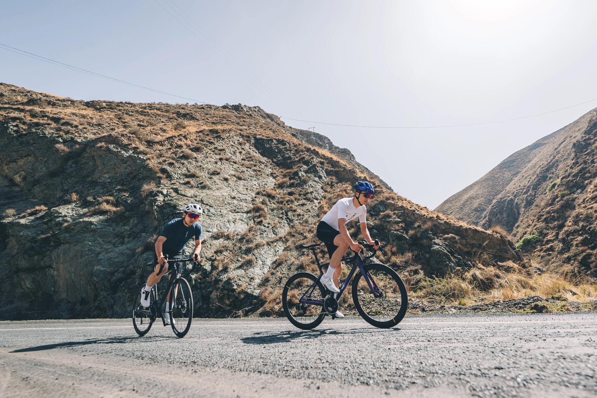 Two cyclists riding Van Rysel bikes