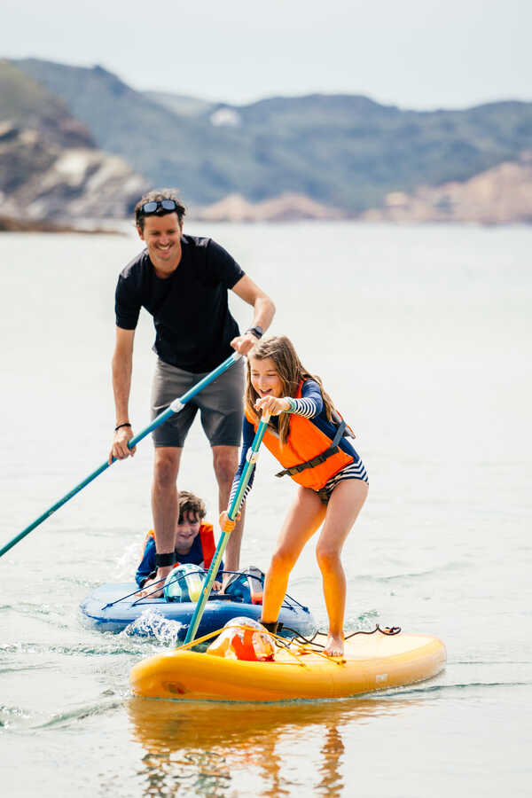 father and dauther ride SUP boards