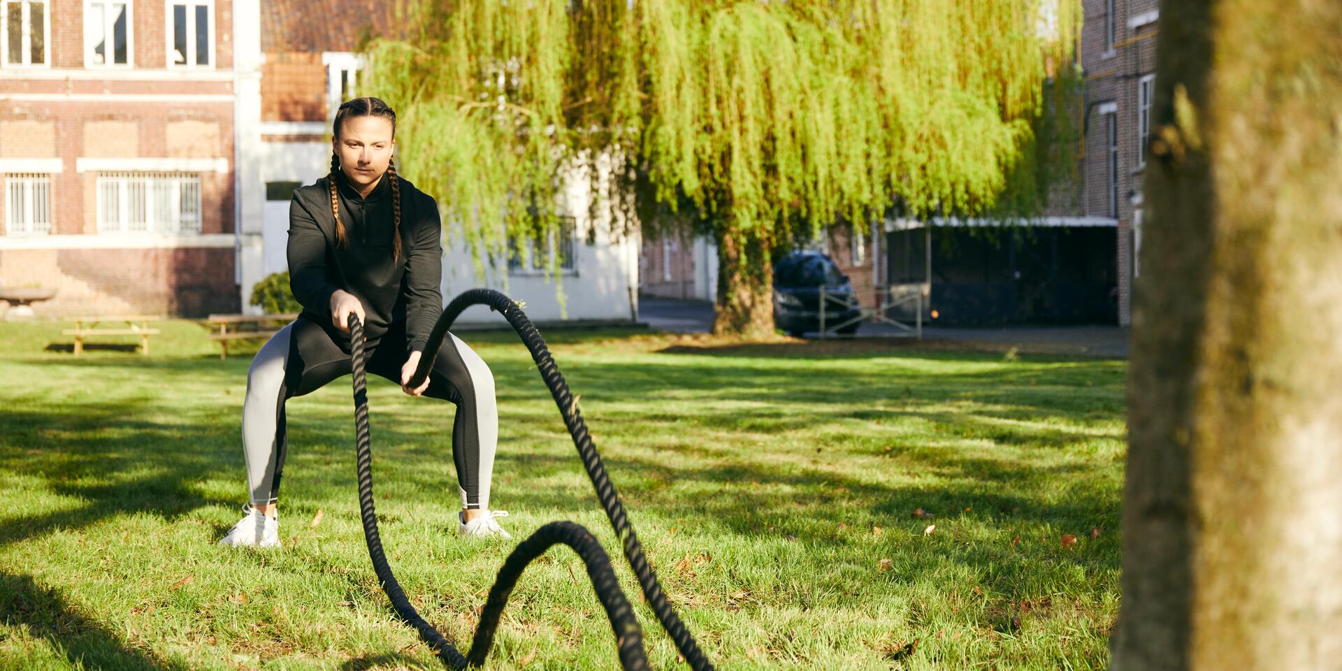 kobieta w odzieży fitness ćwicząca z linami treningowymi