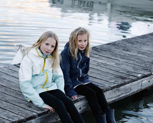 deux filles en vestes imperméables et bottes de pluie