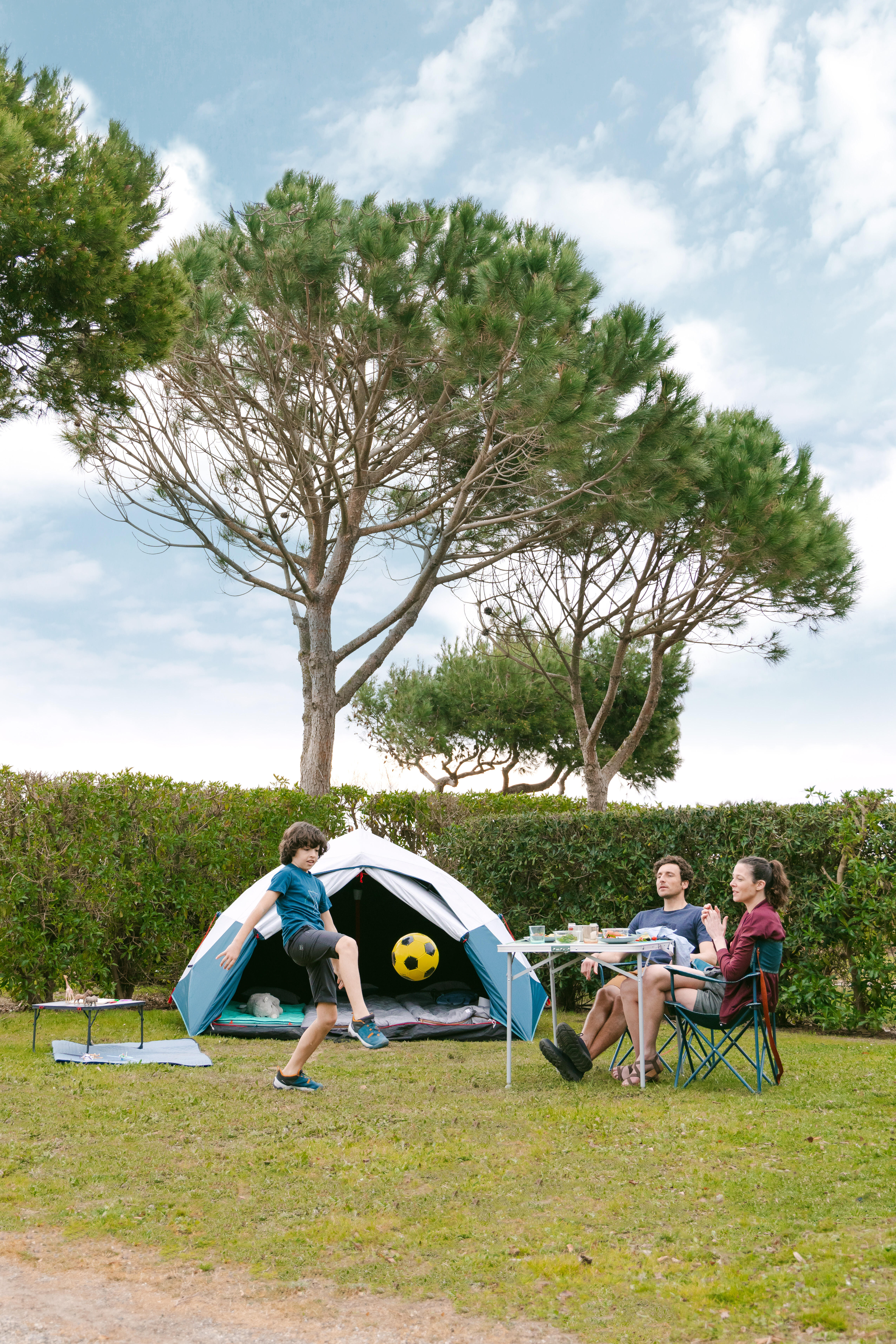 une image d'une famille devant une tente et des chaises randonnée 