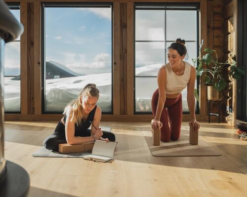 man and woman snowshoeing in the forest